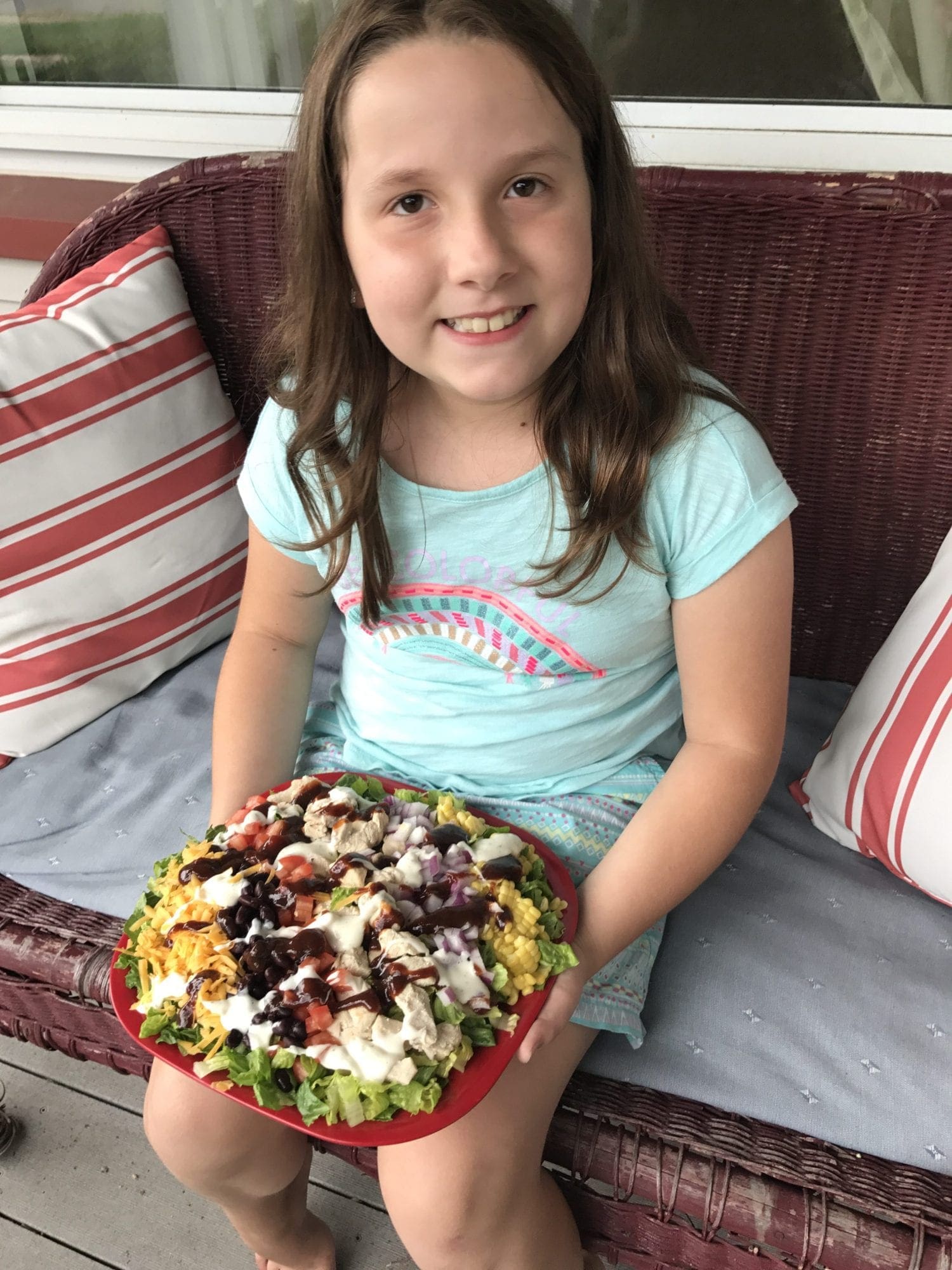 Daughter holding the BBQ Ranch Chicken salad