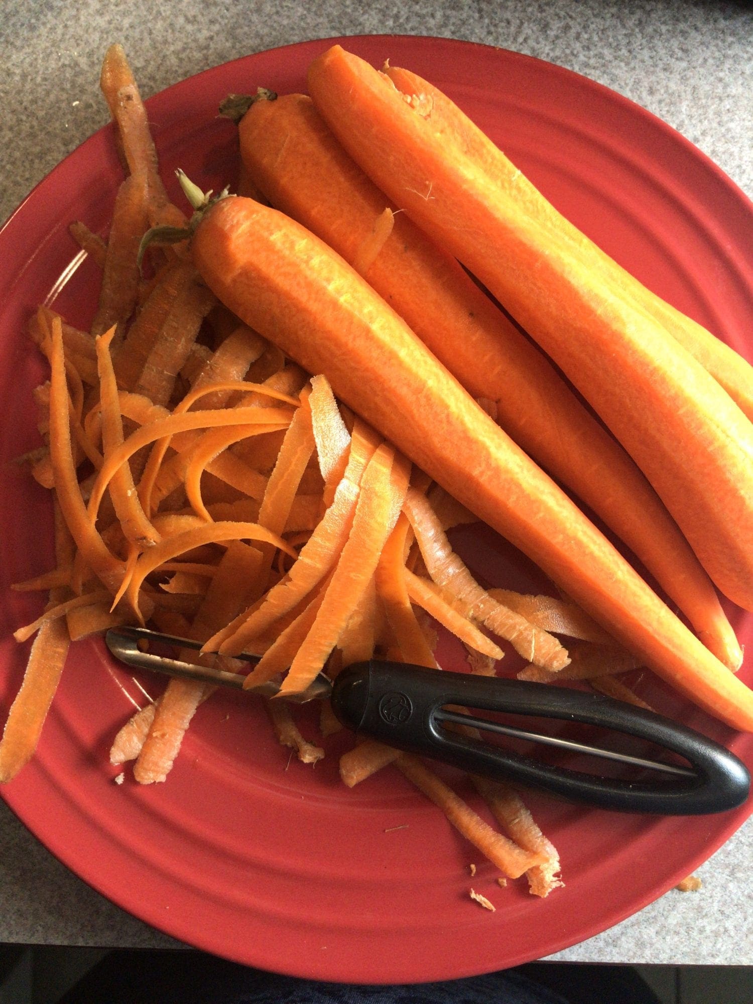 Use a vegetable peeler to peel the carrots.