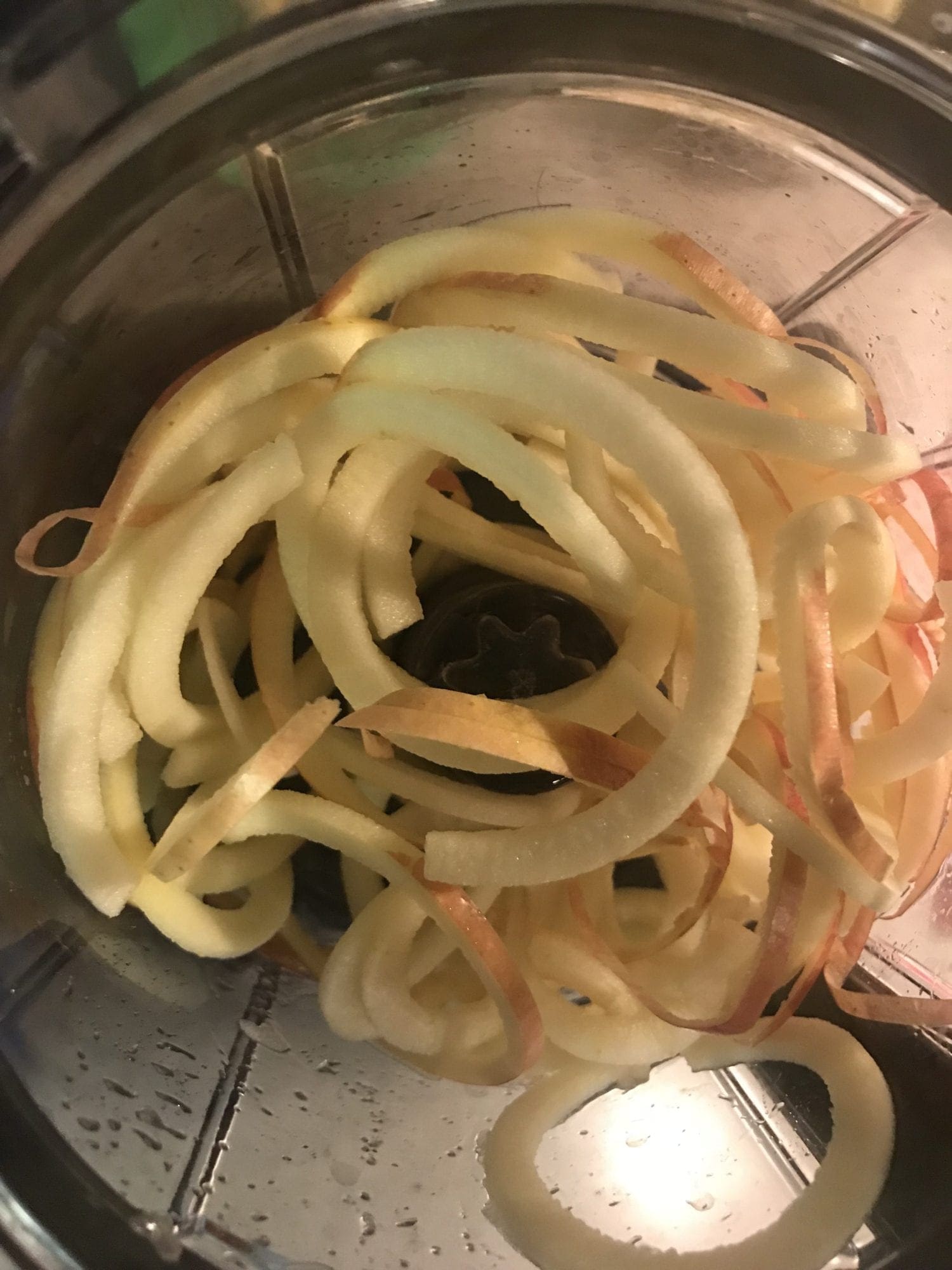 Using a spiralizer to chop apples.