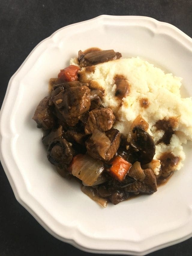 Delicious slow cooker beef burgundy served with mashed potatoes. I love this recipe!