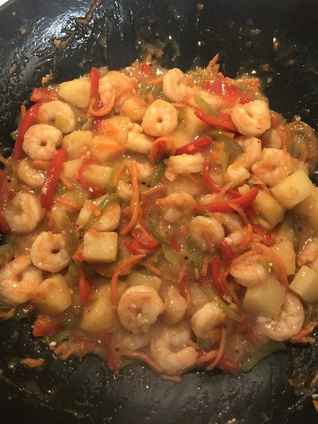 This sweet and sour shrimp stir fry is 4 Weight Watcher SmartPoints on the FreeStyle program. Includes shrimp, pineapple, and bell peppers in a sweet and sour sauce served with brown rice on the side.
