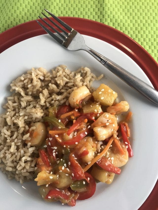 This sweet and sour shrimp stir fry is 4 Weight Watcher SmartPoints on the FreeStyle program. Includes shrimp, pineapple, and bell peppers in a sweet and sour sauce served with brown rice on the side.