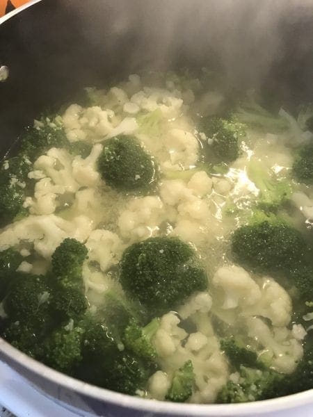 Steam broccoli and cauliflower in boiling water for a few minutes.