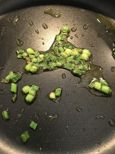 Cook green onion in oil