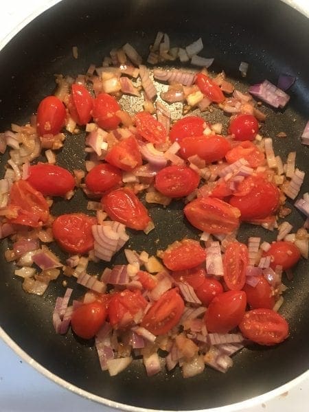 Saute tomatoes, red onion, and garlic for Greek chicken