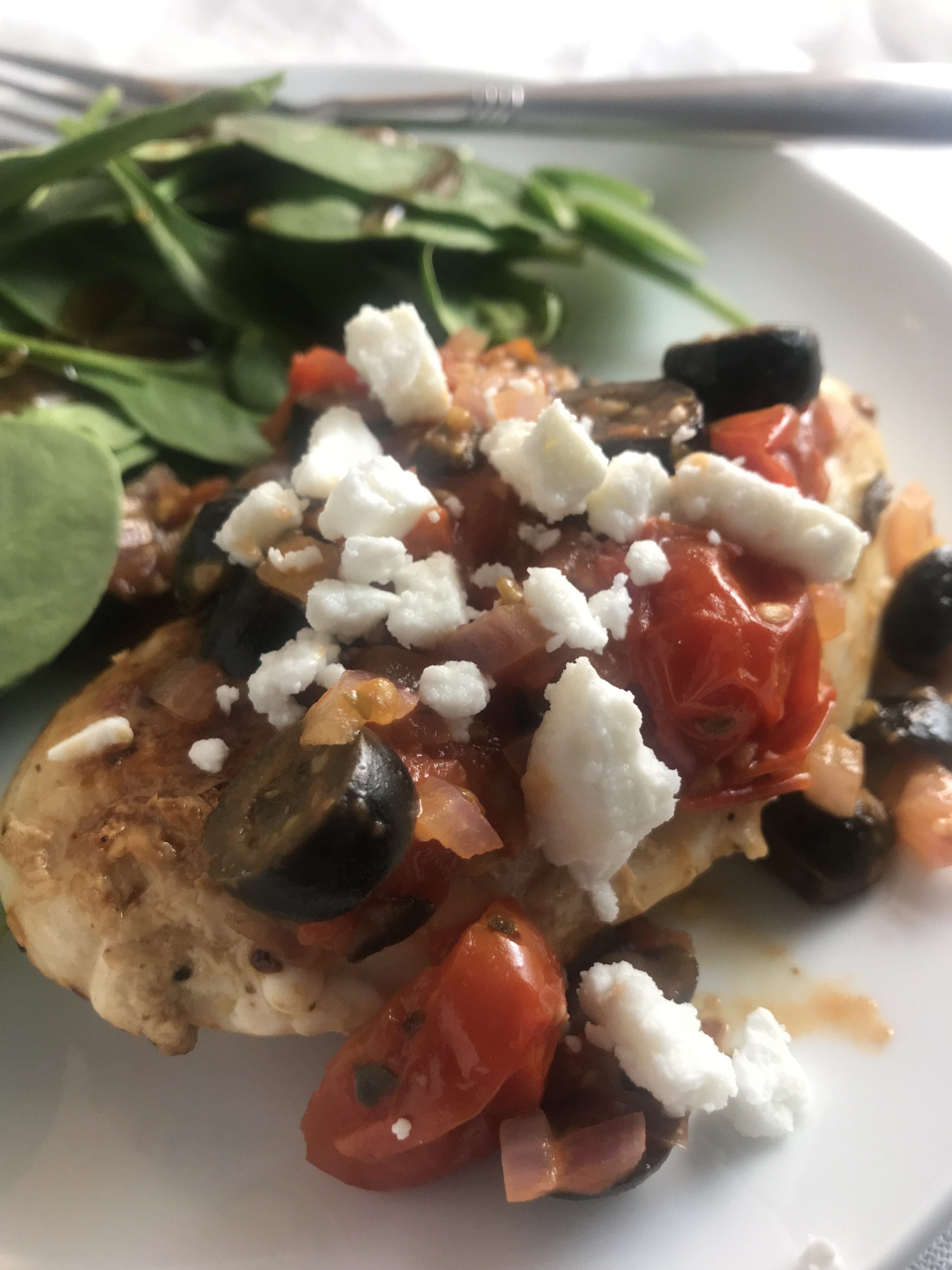 Cherry tomatoes, red onion, garlic, and black olives are sauteed in a vinagrette and piled onto a grilled chicken breast and topped with feta cheese. YUM! Just 3 WW FreeStyle SmartPoints per serving!