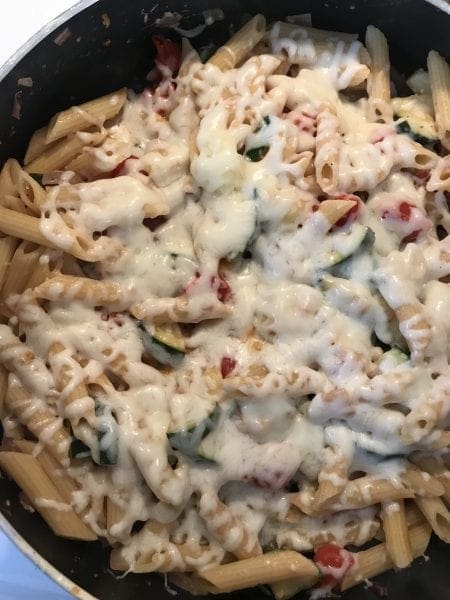 Melt mozzarella cheese on the pasta and veggies by covering skillet as it cooks.
