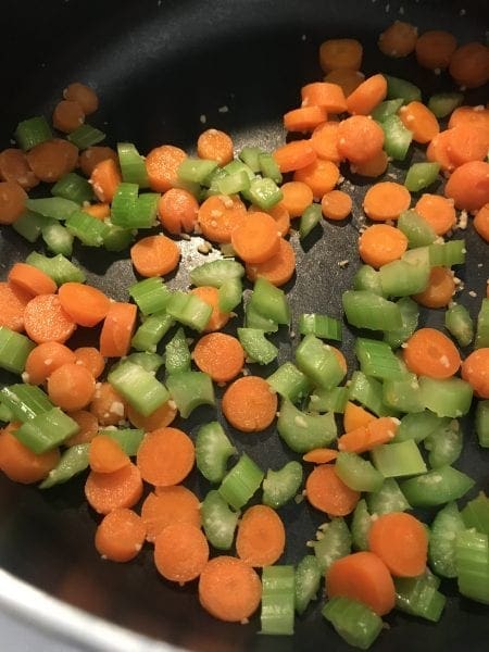 Cook carrots, celery, and garlic for a Tortellini Chicken soup 