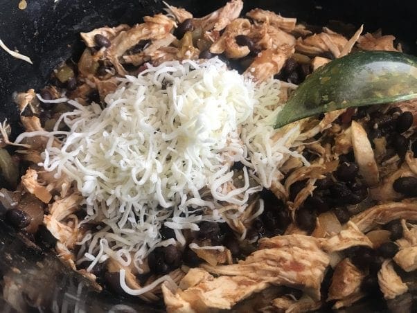 Add black beans and cheese to the shredded Mexican cheese in Chicken Tostadas.