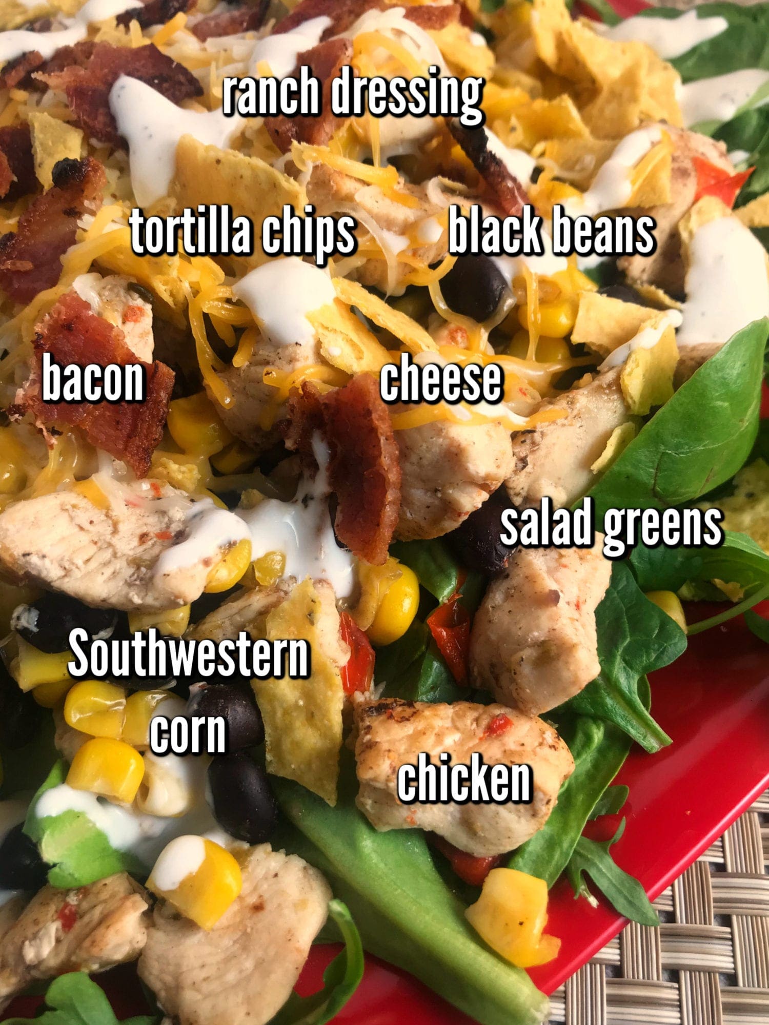 Ingredients to make a delicious Southwest Chicken Bacon and Ranch Salad: salad greens, chicken, bacon, cheese, Southwest corn, black beans, tortilla chips, and Ranch dressing.