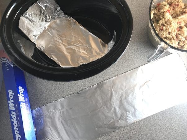 To easily lift a meatloaf or salmon loaf out of a slow cooker, line the slow cooker with two strips of aluminum foil and spray it with cooking spray.