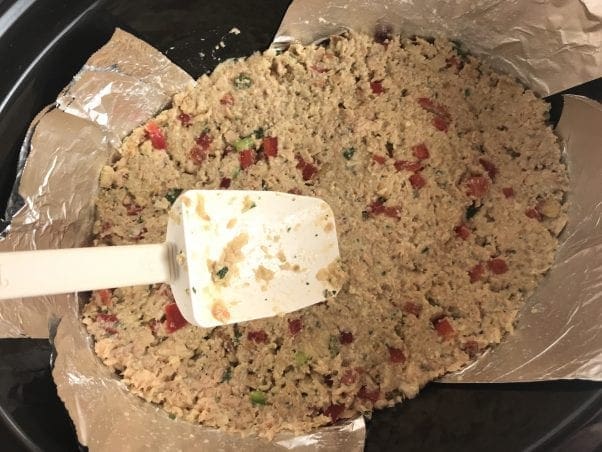 Push salmon loaf mixture into the bottom of the slow cooker.